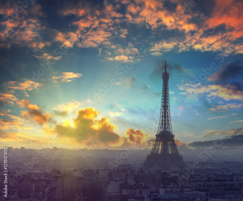 Beautiful sunset and dramatic sky above the Paris, France with Eiffel tower in autumn time at evening. Vintage style travel background