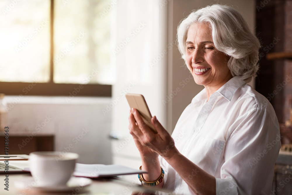 Happy middle-aged lady getting a message Happy middle-aged lady getting a message