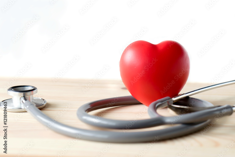 Stethoscope with red heart on a wood background Stethoscope with red heart on a wood background