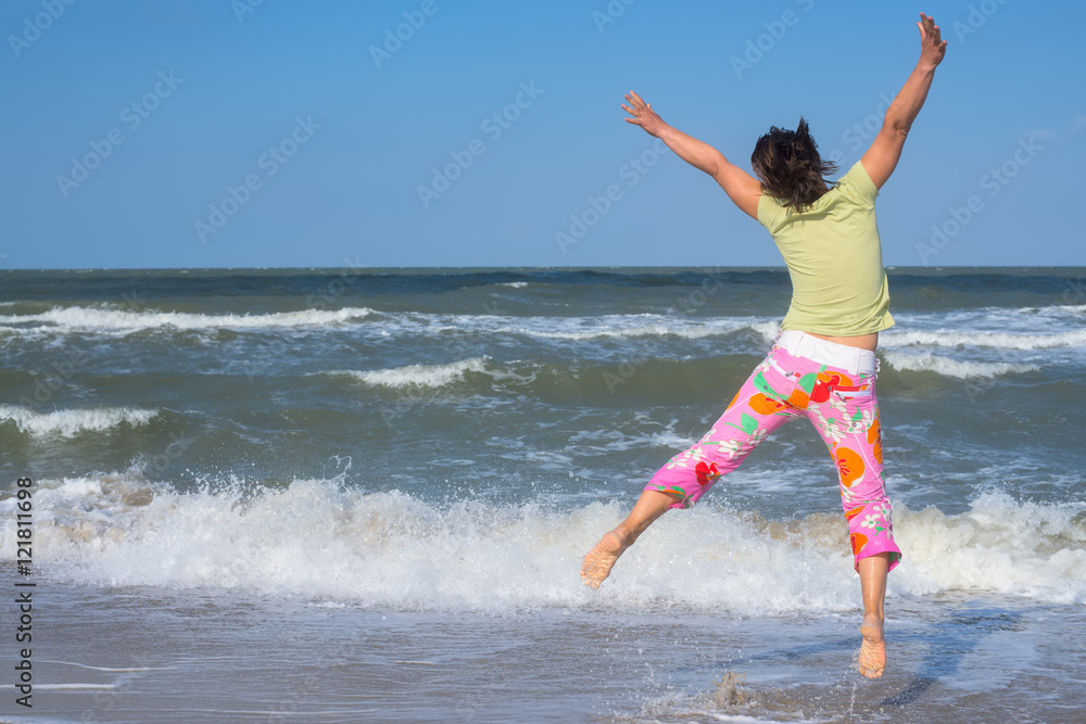 Active woman having fun on beach