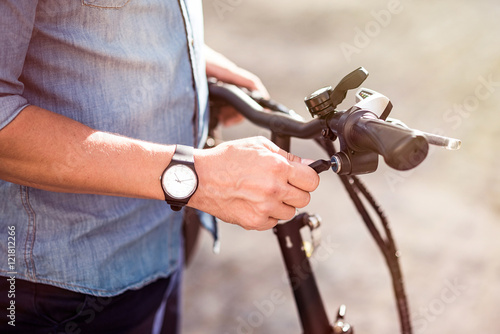 Pleasant man going to ride a bicycle