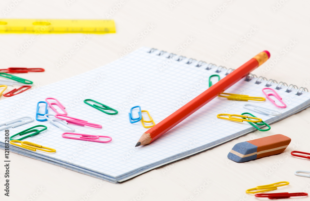Notebook pencil paper clips on a desk Notebook pencil paper clips on a desk