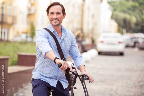 Cheerful man riding a bike © zinkevych