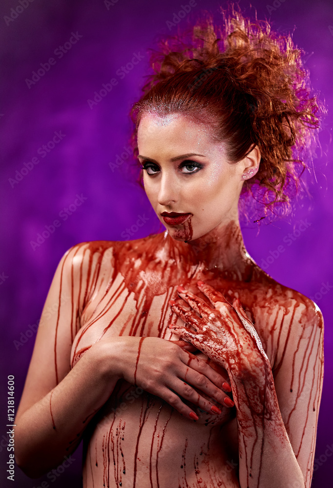 Young woman's body covered with a blood