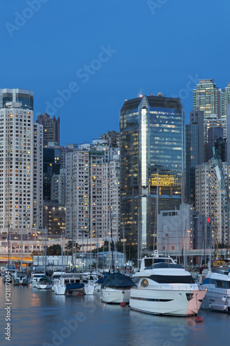 Luxury yacht in port in Hong Kong Harbor at dusk