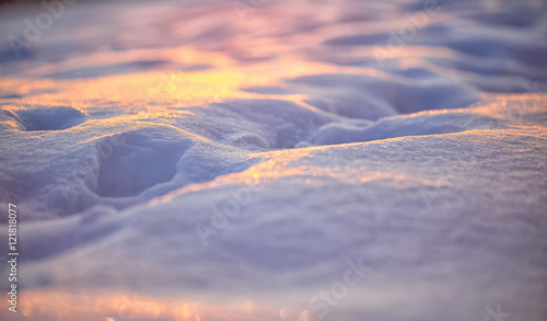 Natural winter background with snow drifts at sunset