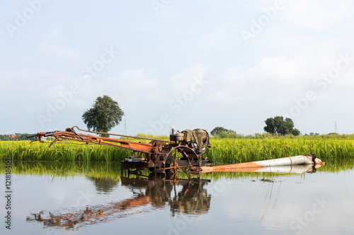 .Tillers reflected in rice paddies. © kaentian