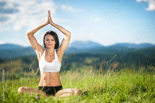 woman meditating in yoga in mountain