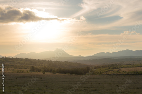 Golden light over fields and mountains
