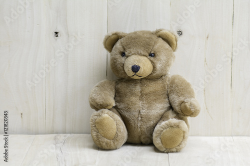Brown teddy bear on wooden floor
