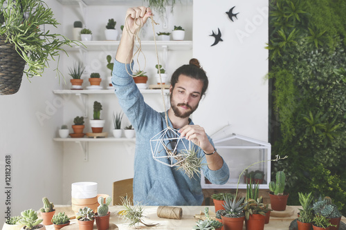 Plant collector preparing the pendant for an air plant photo