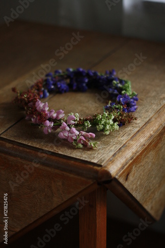 A wildflower wreath on a wooden table