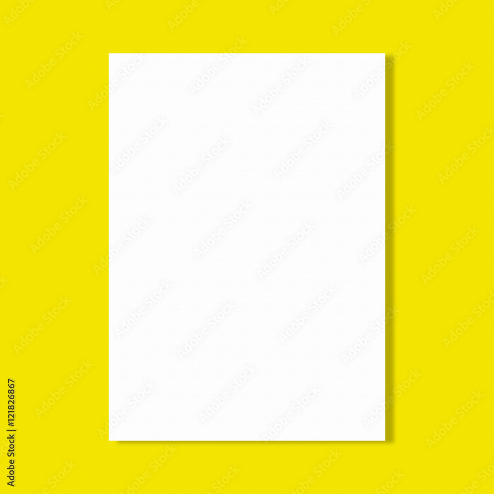 white paper sheet on yellow wall white paper sheet on yellow wall