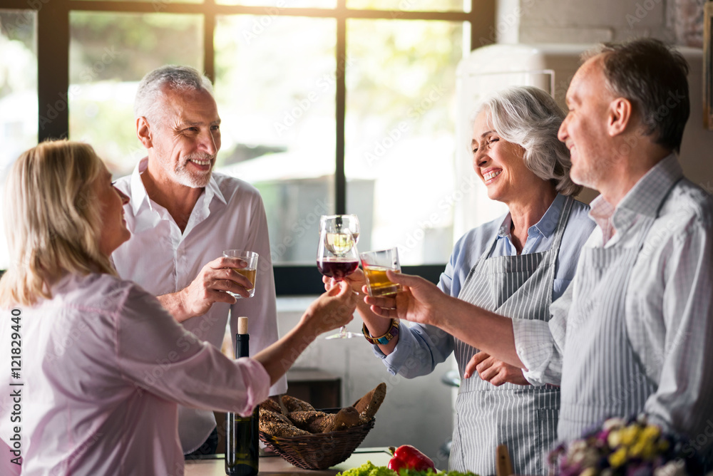 Family cheering with whiskey and wine in kitchen Family cheering with whiskey and wine in kitchen