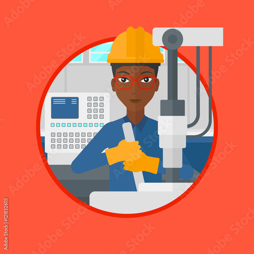 Woman working on industrial drilling machine.