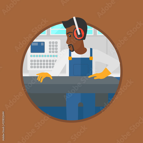 Man working on metal press machine.