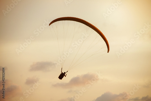 Paraglider flies on background of the sea