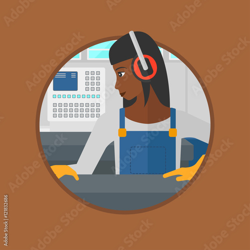 Woman working on metal press machine.