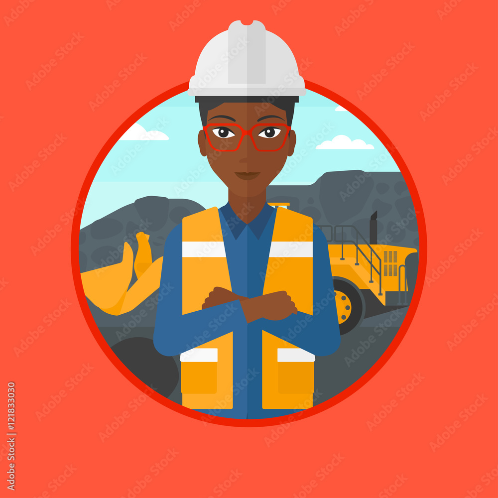 Miner with a big excavator on background.