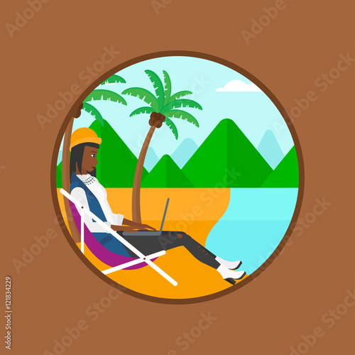 Business woman working on laptop on the beach.