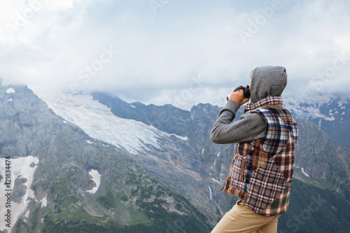 Man drinking hot coffee in mountains