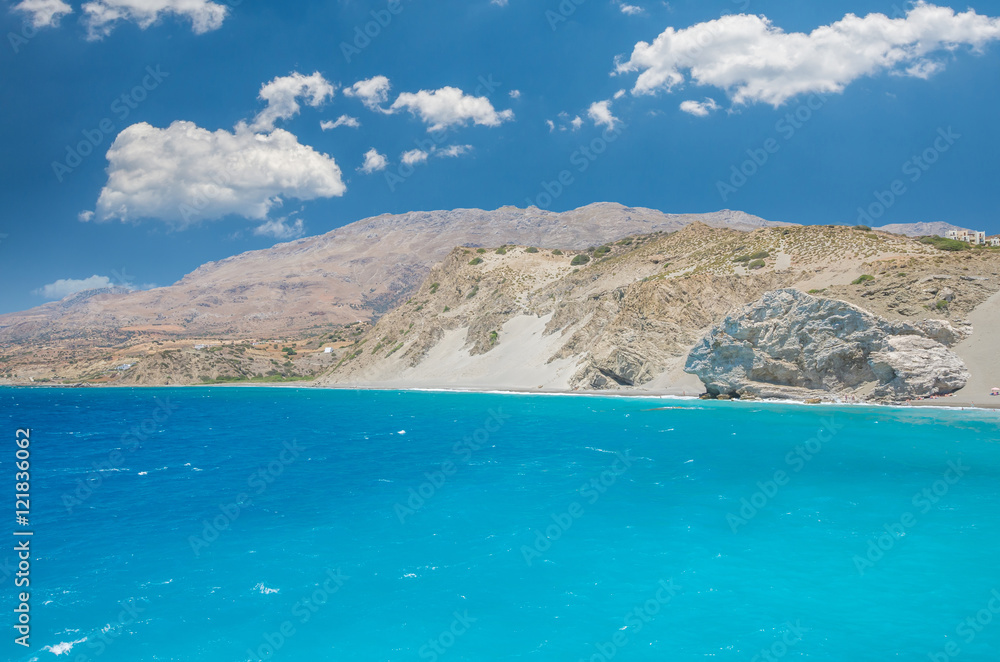 Fototapeta Agios Pavlos Beach in Crete island, Greece. Tourists relax and bath in crystal clear water of St. Paul Sandhill Beach.