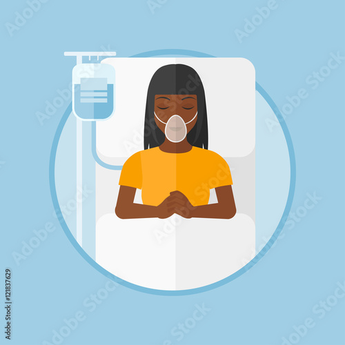 Patient lying in hospital bed with oxygen mask.