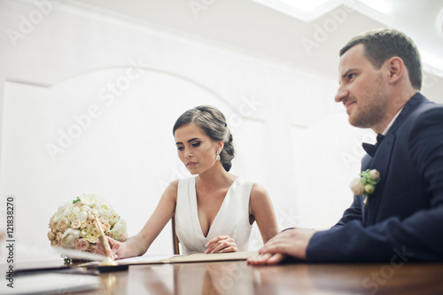 The bride  subscribes on the wedding ceremony