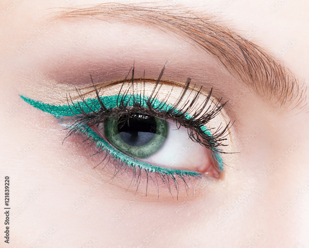 Obraz premium female eye zone and brow with evening green eyeliner makeup