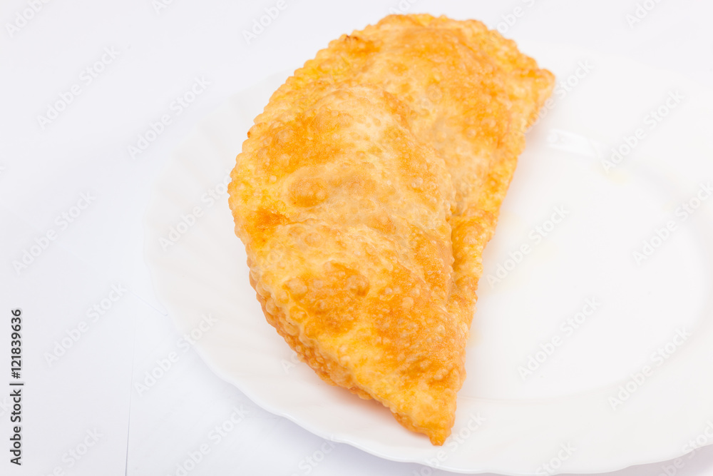 cheburek with lamb on white plate cheburek with lamb on white plate