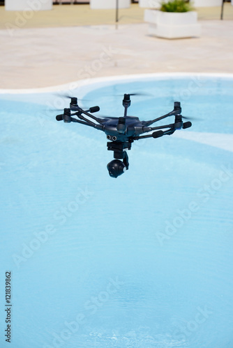 Fototapeta Naklejka Na Ścianę i Meble -  drone hovering over swimming pool