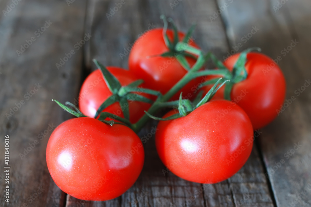 branch of tomatoes on wooden background branch of tomatoes on wooden background
