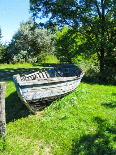 Old wooden boat on a coast of the lake