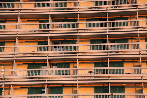 Orange hotel facade with balconies