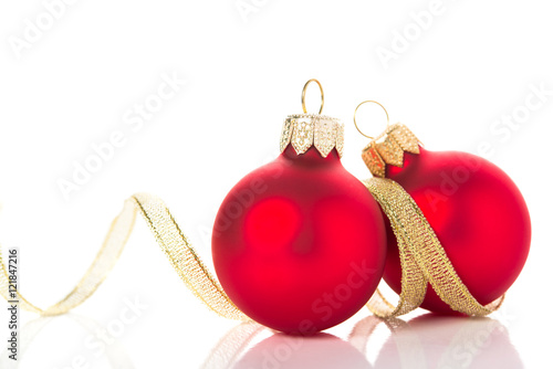 Golden and red christmas ornaments on white background with space for text. Winter holidays. Xmas theme.