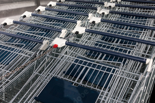 Many empty shopping trolleys in supermarket