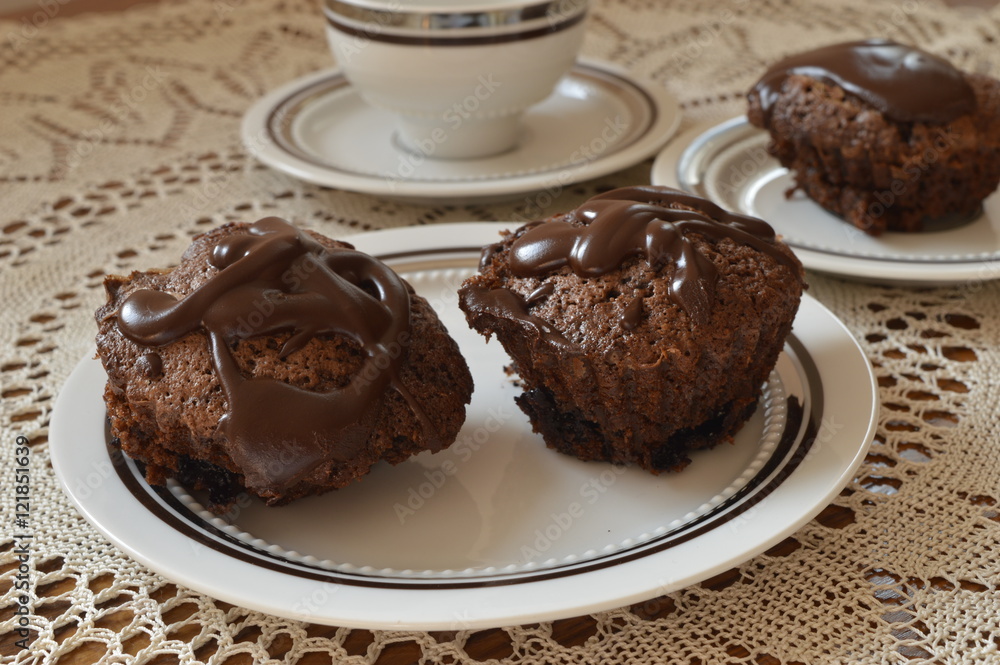 Homemade chocolate muffins heart shaped with chocolate glaze on white plate
Homemade chocolate muffins heart shaped with chocolate glaze on white plate