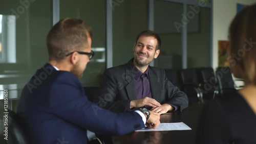 Young couple signing renting contract with real estate agent