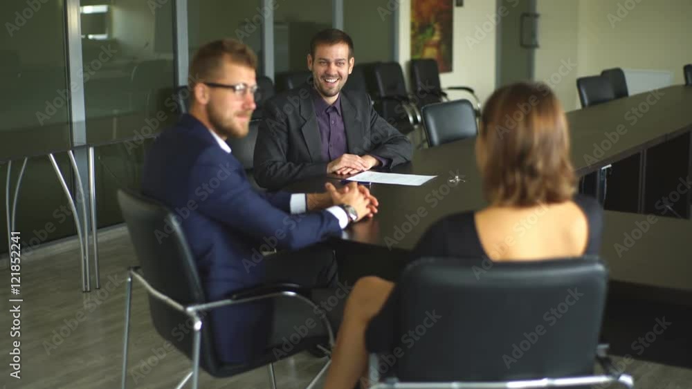 male realtor with key and young couple from back. male realtor with key and young couple from back.