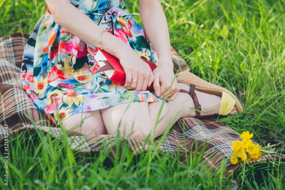 Beautiful woman reading a book in the spring garden Beautiful woman reading a book in the spring garden