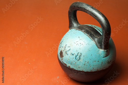 Old weight on a red background