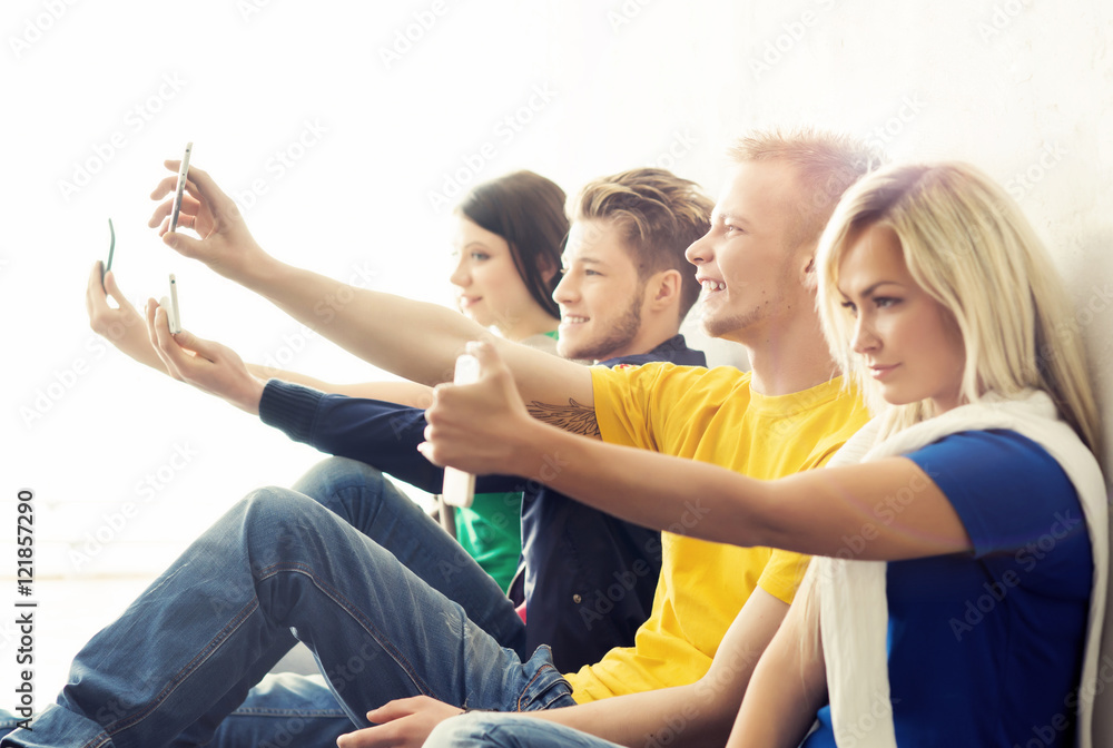 Fototapeta premium Group of hipsters taking a selfie in the school