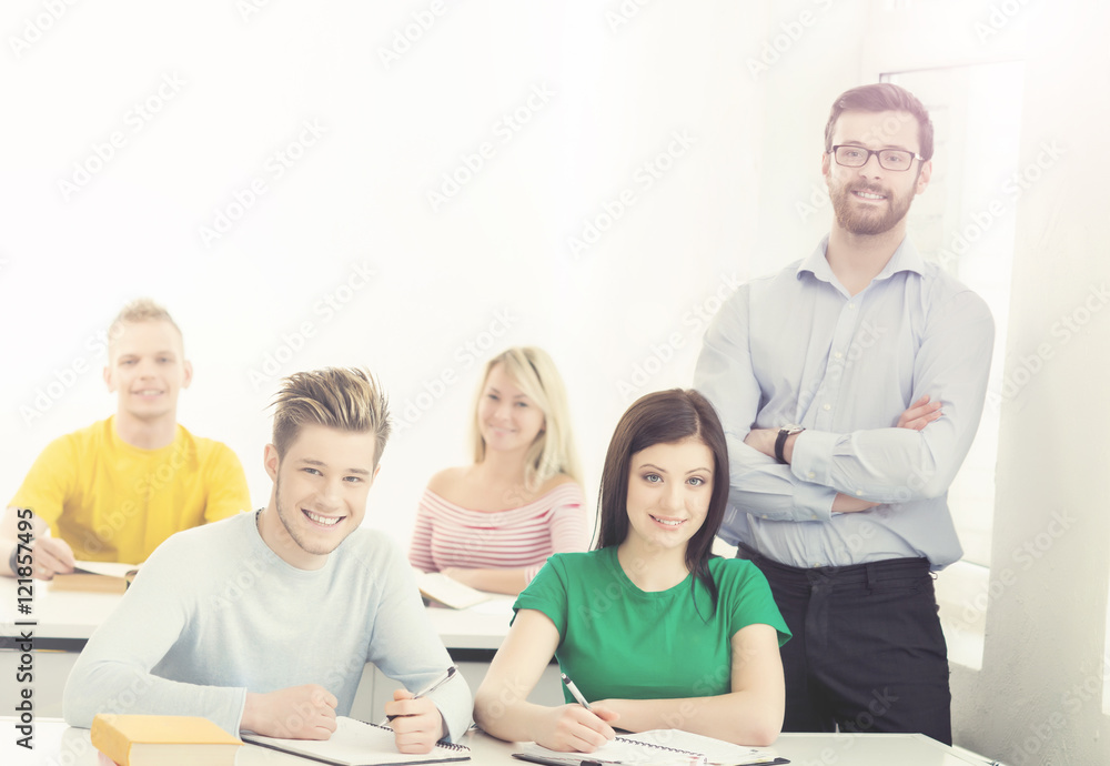 Group of teenage students and a teacher at the lesson Group of teenage students and a teacher at the lesson