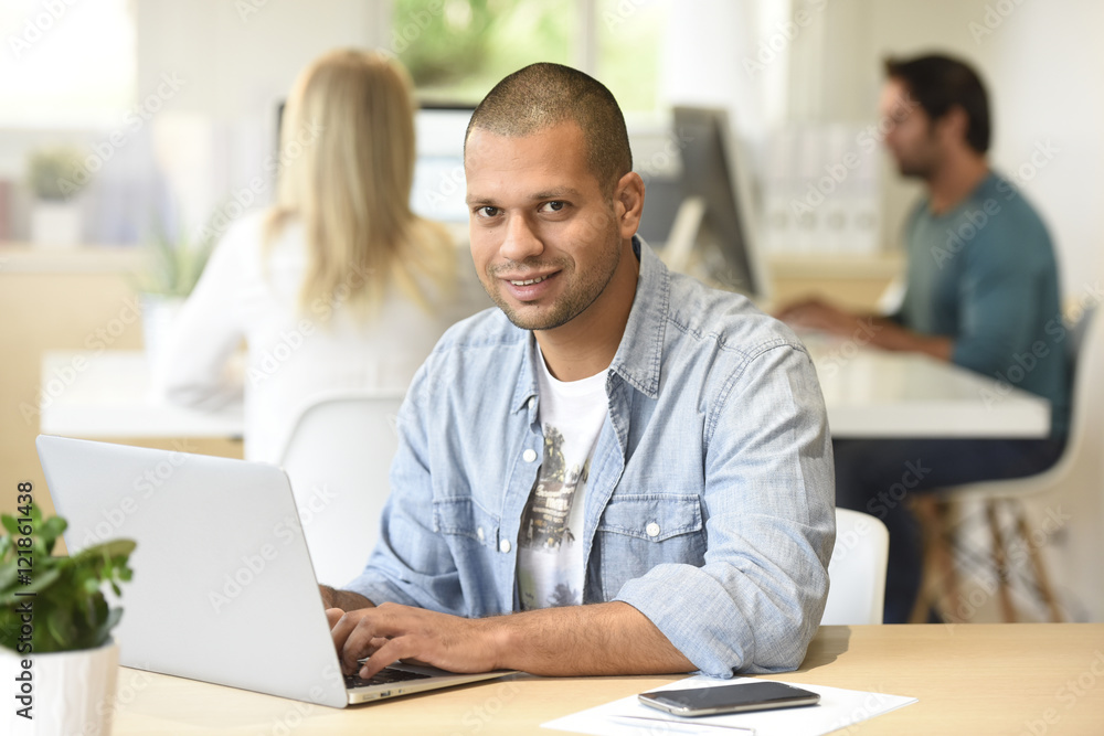 Man in office working on laptop computer Man in office working on laptop computer