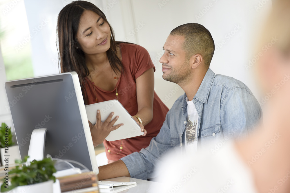 Business people in office working together on desktop Business people in office working together on desktop