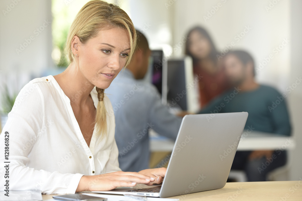 Blond businesswoman working in office Blond businesswoman working in office