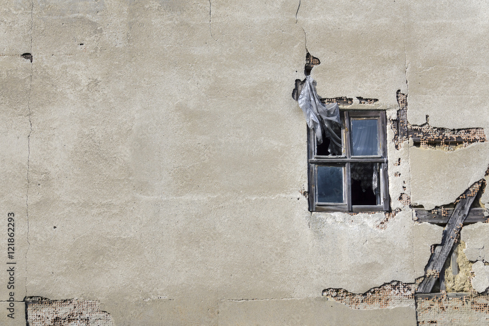 old weathered cement wall exposing broken bricks background with old window old weathered cement wall exposing broken bricks background with old window