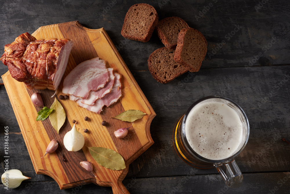 bacon and glass of beer on a table bacon and glass of beer on a table