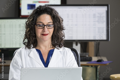 Health professional entering data into computer