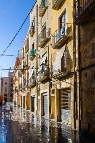 Wet sunny street early morning in Tarragona, Spain © Sergii Zinko